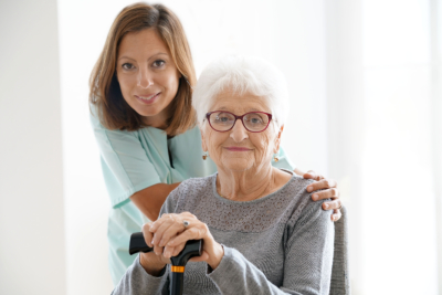 Nurse visiting old woman at home